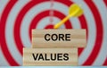 CORE VALUES - an word on wooden blocks against the background of a dartboard