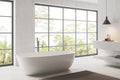 Corenr view of modern bathroom interior with bathtub and panoramic window Royalty Free Stock Photo