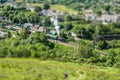 Corfe Castle Rail station with Steam Train departing and green fields Royalty Free Stock Photo