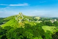 Corfe Castle ruins near Wareham in Dorset, England in the Summer with a clear blue sky and soft white clouds Royalty Free Stock Photo