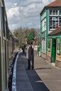 CORFE CASTLE, UK - APRIL 13, 2016: English railways guard waves