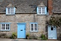 CORFE CASTLE, UK - MAY 21, 2018: The main facade of a medieval house with brickstone and flagstone roof in Corfe Castle village