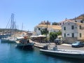 Corfu, Greece - July 7, 2018: Beautiful view of the promenade and Greek houses of Gaios town, Paxos island. Boats and yachts are