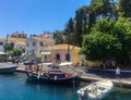 Corfu, Greece - July 7, 2018: Beautiful view of the promenade and Greek houses of Gaios town, Paxos island. Small boats of local