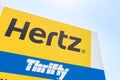 Corfu, Greece - July, 2018: Hertz rent a car sign, against bright sky.