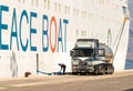 A Volvo truck cistern refueling a cruise ship docked at the Port or Corfu Royalty Free Stock Photo