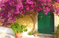 Corfu Island, Greece. Tree with pink flowers and church entrance Royalty Free Stock Photo