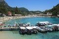 Tourists on the pier waiting to be boarded on boats, on the bottom the green and turquoise sea,