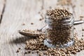 Coriander seed in a glass jar, vintage wooden background, select Royalty Free Stock Photo