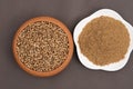 Coriander seeds in a clay bawl, and powder.