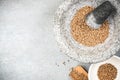 Coriander seeds in granite pestle or mortar Royalty Free Stock Photo