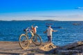Corinto, Nicaragua - May 16, 2018: Unidentified man with his bike enjoying the view of fishing boats in the sea, during Royalty Free Stock Photo