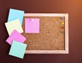 A cork Board with blank colored notes on a brown background. Flatlay Royalty Free Stock Photo