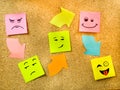 Cork board with colorful post its representing various emoticons with various emotions communication concept