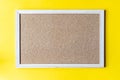 A cork board is a framed section of cork backed with wood or plastic.