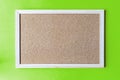 A cork board is a framed section of cork backed with wood or plastic.