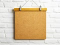 A cork board hanging on a white brick wall Royalty Free Stock Photo