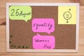 On the cork Board stickers with the inscription August 26 women`s equality day