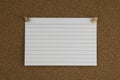 Cork board with tacks and white flash card Royalty Free Stock Photo