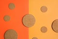 Cork coasters of different sizes on background of orange and yellow color