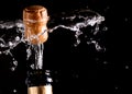 Cork flying from a champagne bottle under the pressure of a liquid
