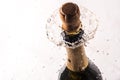 Cork flying from a champagne bottle under the pressure of a liquid