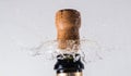 Cork flying from a champagne bottle under the pressure of a liquid