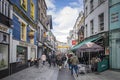 CORK, IRELAND. APRIL 19, 2022. Old city center. Small street with traditional architecture and people walking around