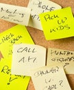 Cork memo board covered with sticky notes with different appointments Royalty Free Stock Photo