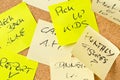 Cork memo board covered with sticky notes with different appointments Royalty Free Stock Photo