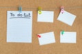 Cork memory board with blank peaces of paper hanging on rope with clothes pin and pinned on board, horizontal