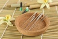 Cork plate with acupuncture needles on bamboo mat Royalty Free Stock Photo