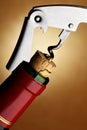 Cork-screw opening wine bottle Royalty Free Stock Photo