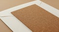 Cork sheet placed on a white envelope, both arranged on a textured brown surface. Royalty Free Stock Photo