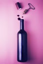 cork from a wine bottle corkscrew shrink wrap and drops of red wine on a pink background Royalty Free Stock Photo