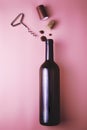 cork from a wine bottle corkscrew shrink wrap and drops of red wine on a pink background Royalty Free Stock Photo