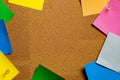 Corkboard/Bulletin Board with a group of various colored sticky notes bordering a central open cork area
