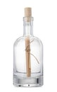 Corked glass bottle with rolled letter isolated on white Royalty Free Stock Photo