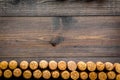 Corks of wine bottles pattern on dark wooden background top view copyspace Royalty Free Stock Photo