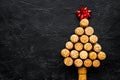 Corks of wine bottles in shape of new year spruce on black background top view copyspace Royalty Free Stock Photo