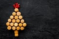 Corks of wine bottles in shape of new year spruce on black background top view copyspace Royalty Free Stock Photo