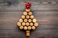 Corks of wine bottles in shape of new year spruce on dark wooden background top view copyspace Royalty Free Stock Photo