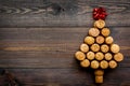 Corks of wine bottles in shape of new year spruce on dark wooden background top view copyspace Royalty Free Stock Photo