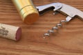Corkscrew with Cork and Bottleneck on wooden Background