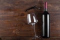 Corkscrew, glass and bottle of red wine on a wooden background. Top view Royalty Free Stock Photo