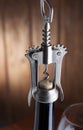 Corkscrew and a glass of wine on an old wooden table Royalty Free Stock Photo