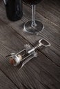 Corkscrew and a glass of wine on an old wooden table Royalty Free Stock Photo