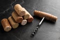 Corkscrew and stack of wine bottle stoppers on slate table, closeup Royalty Free Stock Photo