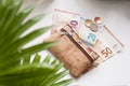 Corkwood wallet and money on a white background. Ten, twenty and fifty euro bills and some coins.