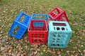 Corlorful plastic boxes for beer bottles on autumn meadow Royalty Free Stock Photo